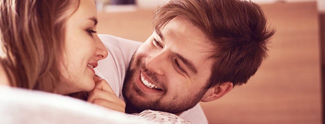 Frau und Mann liegen im Bett beieinander und sind unsicher ob Beziehung am Ende ist